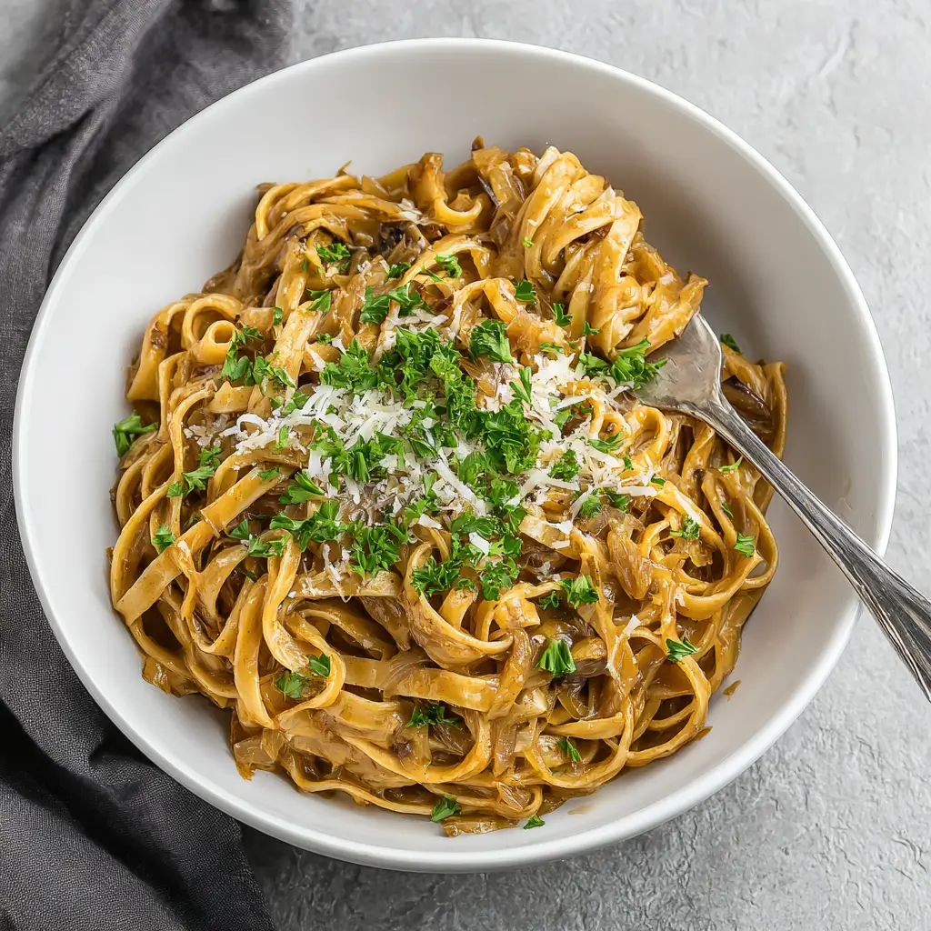 Gluten Free One-Pot French Onion Pasta That’s Rich, Cozy & Ready Fast 2 Served Gluten Free One-Pot French Onion Pasta topped with herbs and parmesan